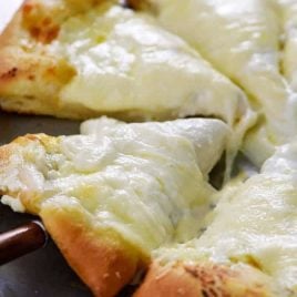 A simple recipe for homemade three cheese pizza that takes ordinary cheese pizza to a whole new level! // addapinch.com