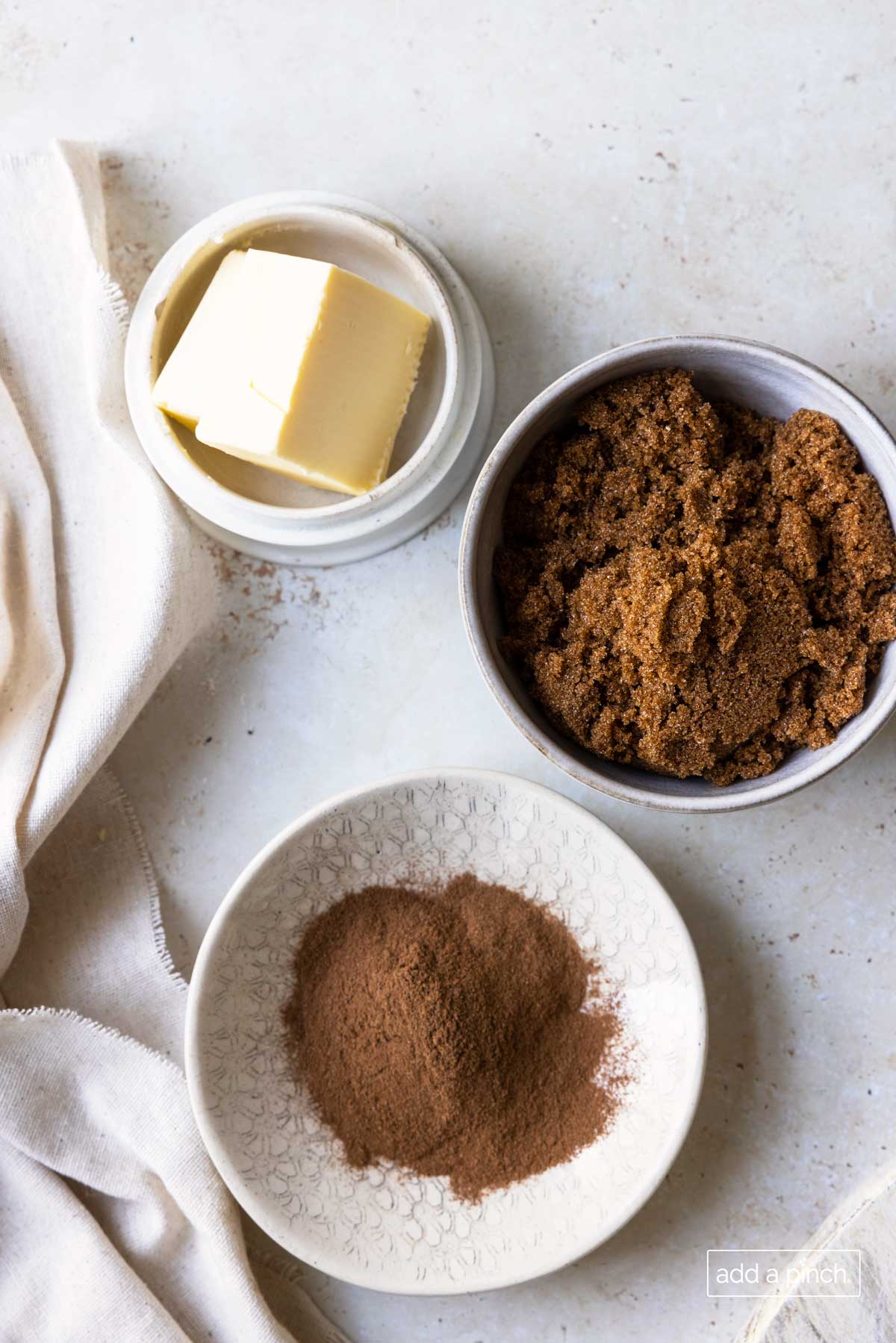 Containers of ingredients to make Cinnamon Roll filling - butter, brown sugar, and cinnamon.