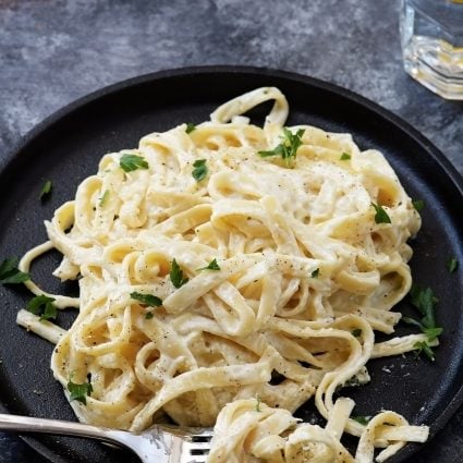 Alfredo Sauce Recipe - Made of cream, butter, and garlic, this quick and easy alfredo sauce recipe comes together quickly for a comforting homemade classic! // addapinch.com