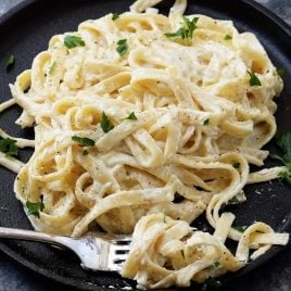 Alfredo Sauce Recipe - Made of cream, butter, and garlic, this quick and easy alfredo sauce recipe comes together quickly for a comforting homemade classic! // addapinch.com