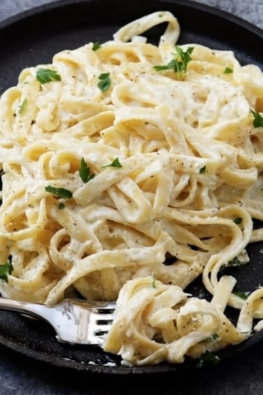 Alfredo Sauce Recipe - Made of cream, butter, and garlic, this quick and easy alfredo sauce recipe comes together quickly for a comforting homemade classic! // addapinch.com