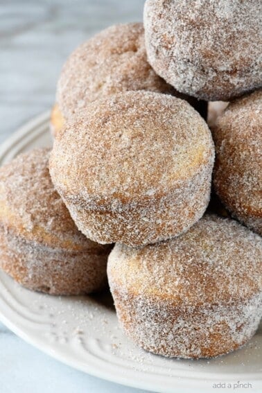 Apple Cider Donut Muffins Recipe - These apple cider muffins are light, fluffy and coated in an amazing cinnamon sugar coating! // addapinch.com