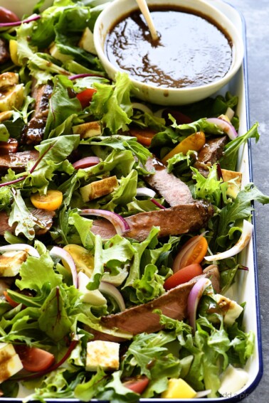 Balsamic Steak Salad Recipe - A hearty balsamic steak salad recipe is served with lots fresh vegetables, mozzarella, fresh basil and a Homemade Balsamic Vinaigrette. // addapinch.com