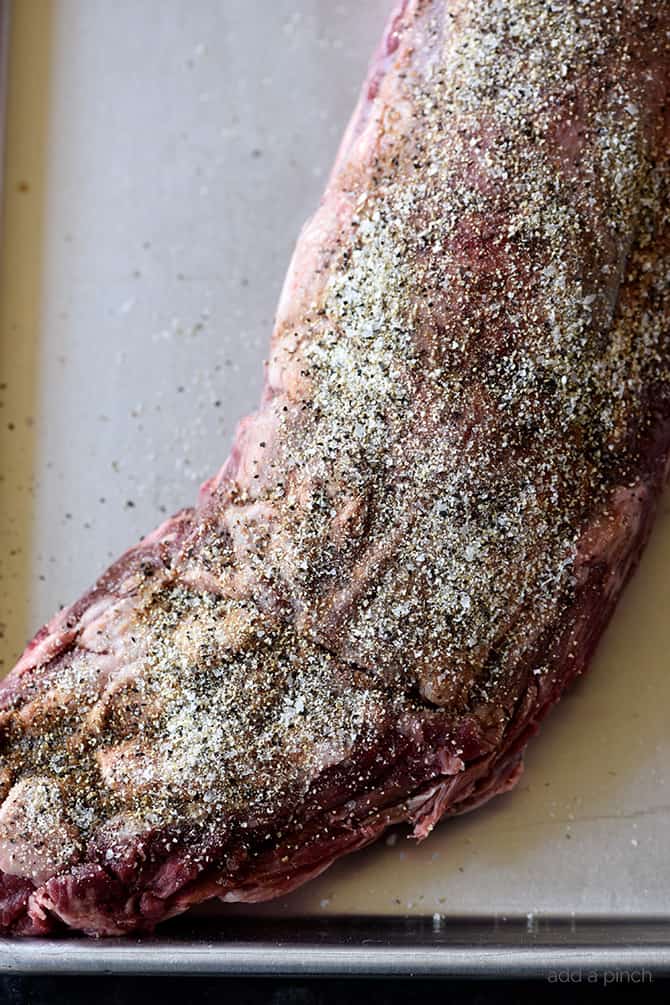 Beef Tenderloin covered in Stone House Seasoning to dry brine the beef, all on a rimmed baking sheet. 