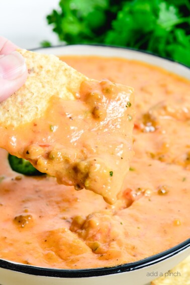 This Chili Cheese Dip makes the best quick and easy cheese dip! Made from scratch with shredded cheese, salsa, and cooked sausage, it is always a favorite! // addapinch.com