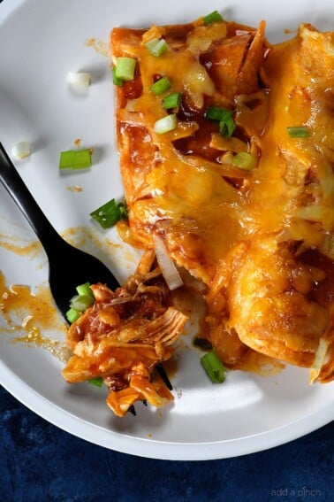 Buffalo Chicken Enchiladas Recipe - These quick and easy buffalo chicken enchiladas are so simple, yet scrumptious! Ready and on the table in 30 minutes! // addapinch.com