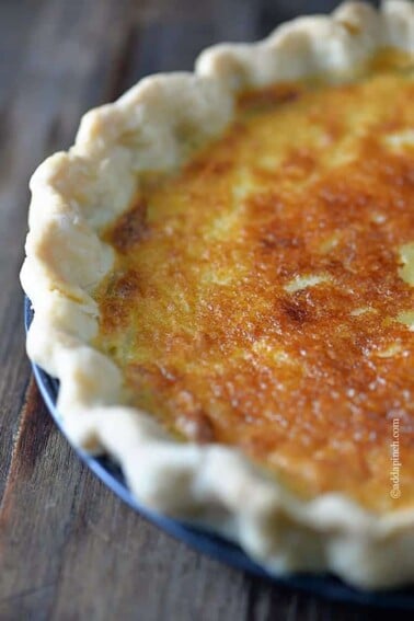 Golden baked Buttermilk Pie in a fluted, homemade pie crust.