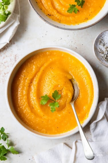 Roasted butternut squash soup with parsley garnish.