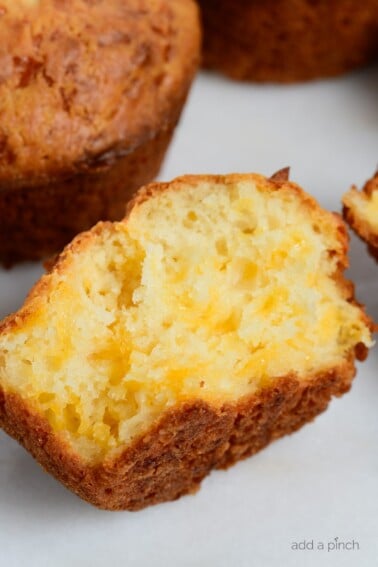 Easy Cheddar Cheese Muffins are so moist, tender and delicious! This cheesy bread is perfect for serving with soup, stew, BBQ or any meal! // addapinch.com