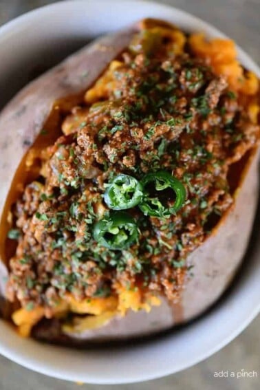 Chili Stuffed Sweet Potatoes Recipe - Chili Stuffed Sweet Potatoes makes a quick and easy meal! Ready and on the table in 30 minutes or a great make-ahead meal for even easier weeknights! // addapinch.com