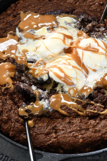 Double Chocolate Caramel Skillet Cookie Recipe - This scrumptious chocolate cookie recipe brings together the richness of chocolate and creamy caramel all in one delicious skillet recipe! // addapinch.com