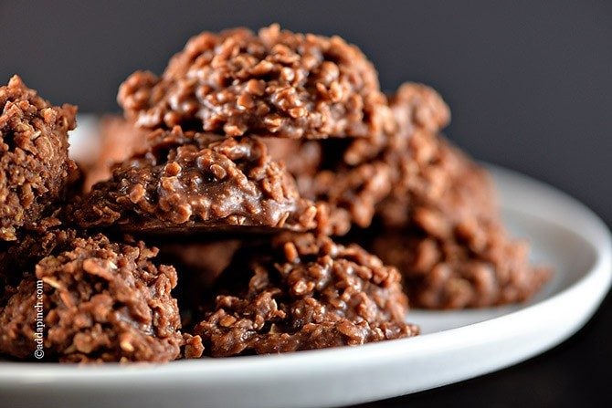 Close up photograph of chocolate cookies on a white platter with a dark background. // addapinch.com