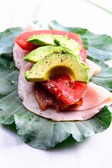 Collard Wrap Recipe - Collard wraps make a fresh, delicious, and nutrient dense way to update your favorite wraps or sandwiches! Made with turkey, bacon, tomato and avocado, these collard wraps are sure to become a favorite! // addapinch.com