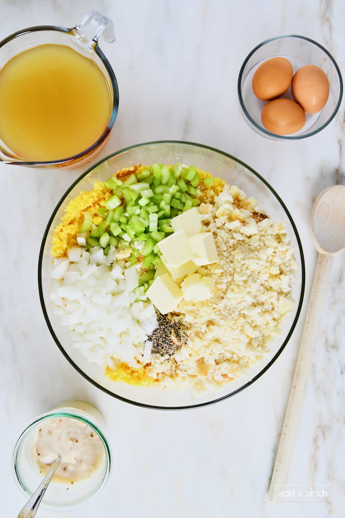 Ingredients for cornbread dressing in a glass mixing bowl