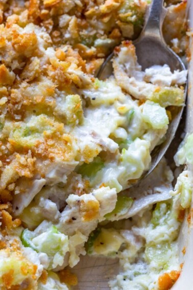 Hot chicken salad baked in a white baking dish.