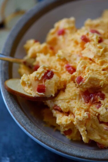 Southern Pimento Cheese Recipe - A staple spread in Southern home and parties, pimento cheese is a classic! Made with cheddar cheese, pimentos and a secret ingredient, this pimento cheese recipe is always a hit! // addapinch.com