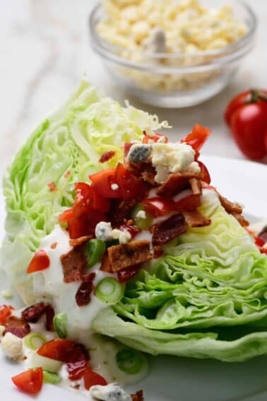 Classic wedge salad with bacon, tomatoes, homemade dressing.