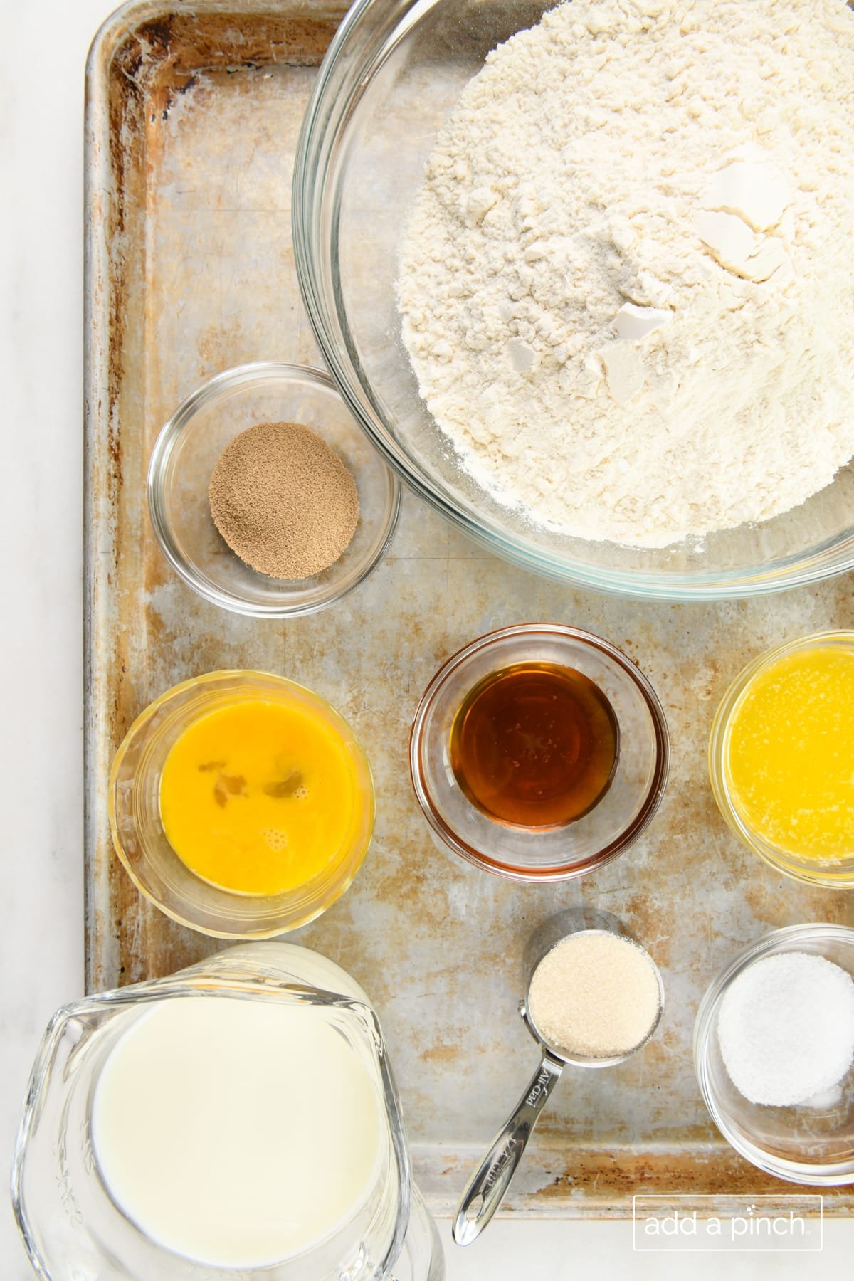 Ingredients to make easy dinner rolls on a baking sheet.