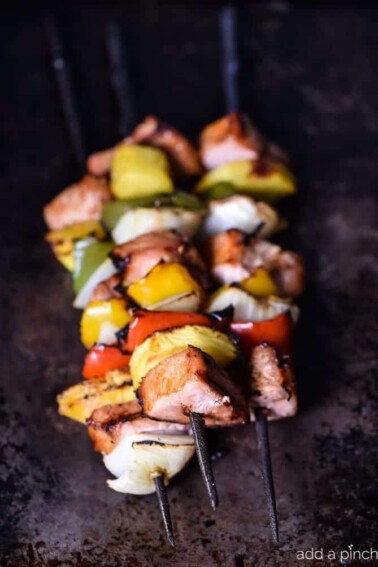 These easy grilled pork tenderloin and pineapple skewers are a quick-fix family favorite! Ready in minutes and so delicious! // addapinch.com