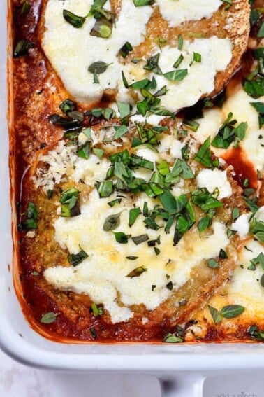 Eggplant Parmesan Recipe - Eggplant Parmesan makes a delicious and family favorite meal. This no-fry eggplant parmesan recipe is layered with baked eggplant, tomato sauce and cheese for a meatless meal the whole family loves! // addapinch.com