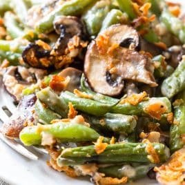 Photo of green bean casserole on a white plate.