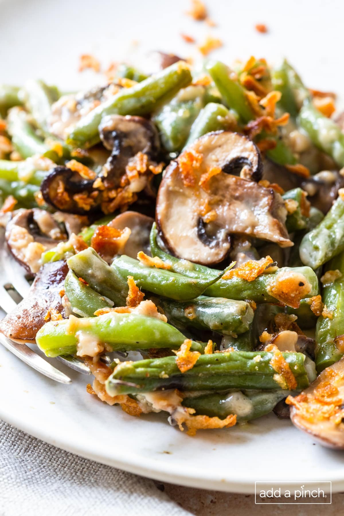 Photo of green bean casserole on a white plate.