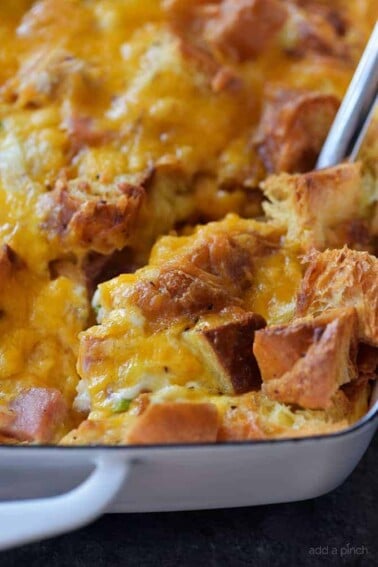 Ham and Cheese Croissant Casserole Recipe - An easy and delicious breakfast casserole that everyone loves! Made of ham, two cheeses, and buttery croissants and baked to perfection! // addapinch.com