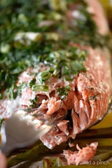 Herb Crusted Salmon in Foil Recipe - A quick and easy baked salmon recipe perfect for a busy weeknight or serving when company comes! A one pan meal that everyone loves made of asparagus, lemon, salmon, topped with an herb crust and baked until tender and delicious! // addapinch.com