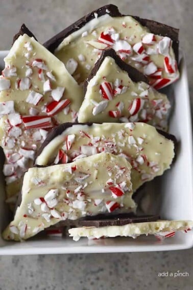 Homemade Peppermint Bark Recipe - Peppermint Bark makes a favorite holiday treat! This homemade peppermint bark recipe is made with layers of peppermint filled milk chocolate and white chocolate and then topped with peppermint candy. // addapinch.com