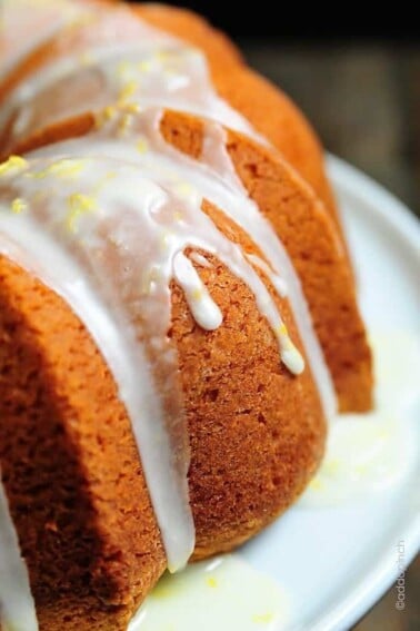 Side view of lemon pound cake with lemon buttermilk glaze drizzled on top.