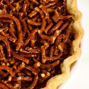 Mock pecan pie in a pie plate on a white surface.