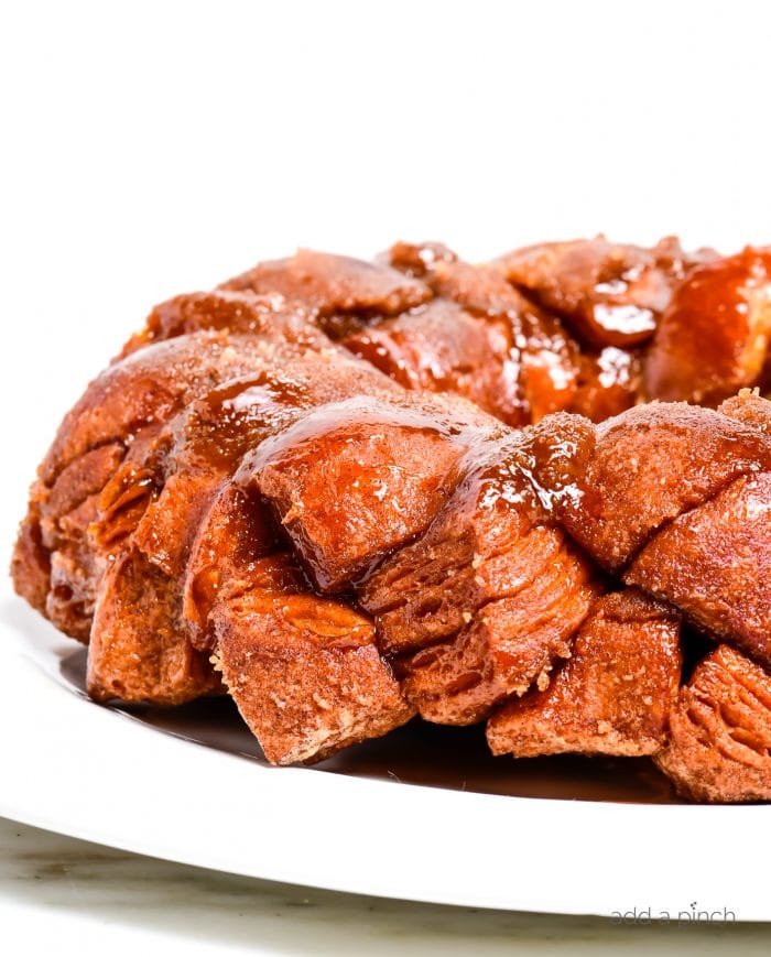 Photograph of easy monkey bread on a white plate on a marble table. 