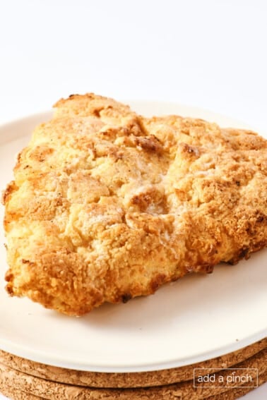 Crispy oven fried chicken on a white plate on a white background.