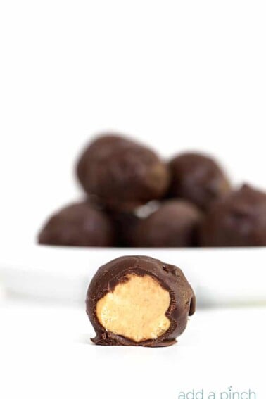 Peanut Butter Balls Recipe - the perfect combination of peanut butter and chocolate! This simple, no-bake recipe makes peanut butter balls everyone loves! // addapinch.com