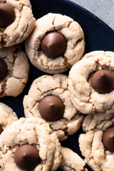 Peanut Butter Blossoms Recipe - This soft classic peanut butter cookie topped with a milk chocolate kiss is always a favorite! // addapinch.com