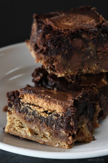 Peanut Butter Cup Brookies Recipe - This recipe takes brownies to a whole new level! Layers of chocolate chip cookie, fudgy brownies, and peanut butter cups make a dessert that everyone loves! // addapinch.com