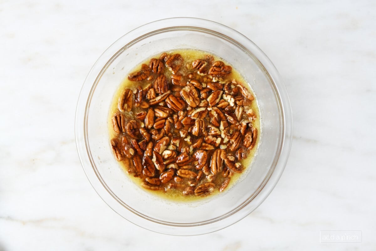 Ingredients for pecan pie bar filling in a glass mixing bowl. 