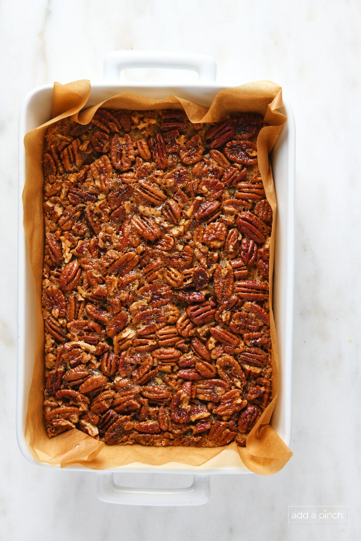 Pecan pie bars in a baking dish.