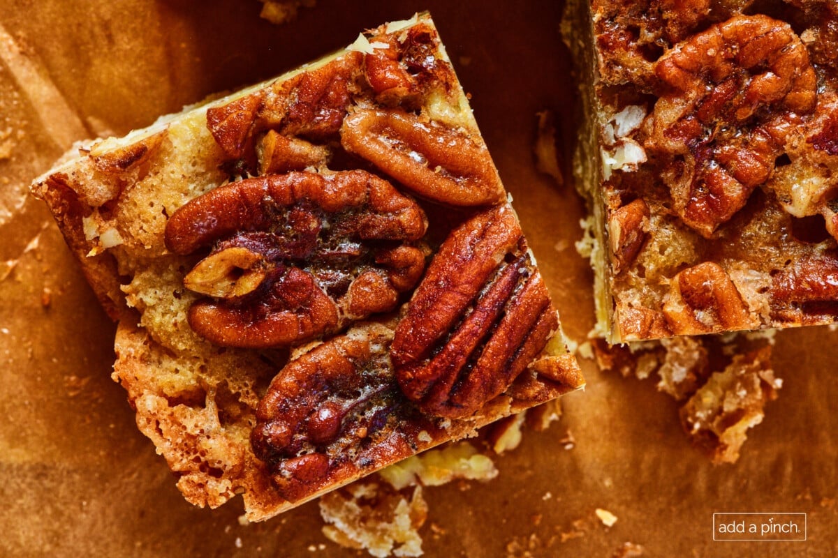 Pecan Pie Bar square on a piece of parchment paper.