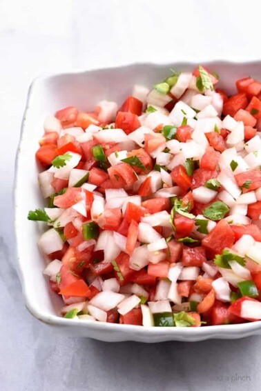 Pico de Gallo Recipe - Pico de Gallo has to be one of the simplest recipes to make and adds so, so, so much flavor to any number of dishes as a topping or just right by itself on a chip! // addapinch.com