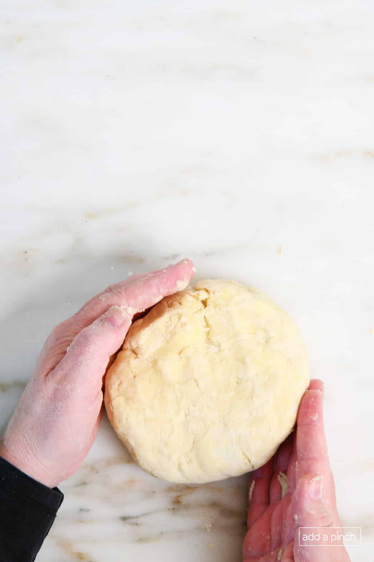 Pie dough has been blended and formed into a ball prior to rolling out.