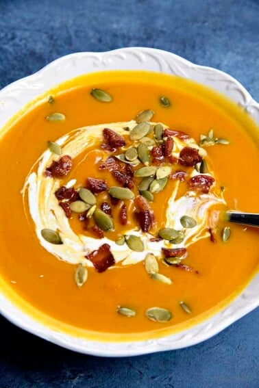 Creamy Pumpkin Soup Recipe - This classic pumpkin soup recipe is creamy, dreamy and made without cream! Quick and easy, this pumpkin soup comes together in a snap for simple weeknight or when entertaining through the holidays! // addapinch.com