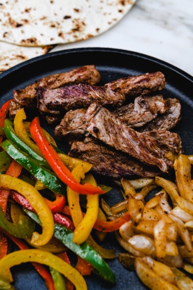 Rib Eye Fajitas Recipe - Ribeye Steak Fajitas are so quick, easy and flavorful! Made with perfectly seasoned, tender Ribeye steak, bell peppers and onions, they are always a favorite! // addapinch.com