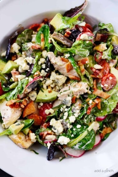 Rosemary Chicken Salad Recipe with Rosemary Ranch Dressing - Tender baked rosemary chicken is the star in this loaded salad recipe topped with a flavorful rosemary ranch dressing. The perfect combination of crunch, creamy, salty and so, so good! // addapinch.com