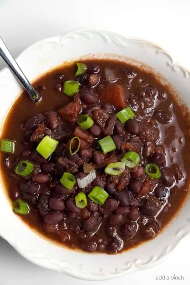 Black Bean Soup Recipe - This delicious black bean soup is packed with flavor and made even easier with the slow cooker! // addapinch.com