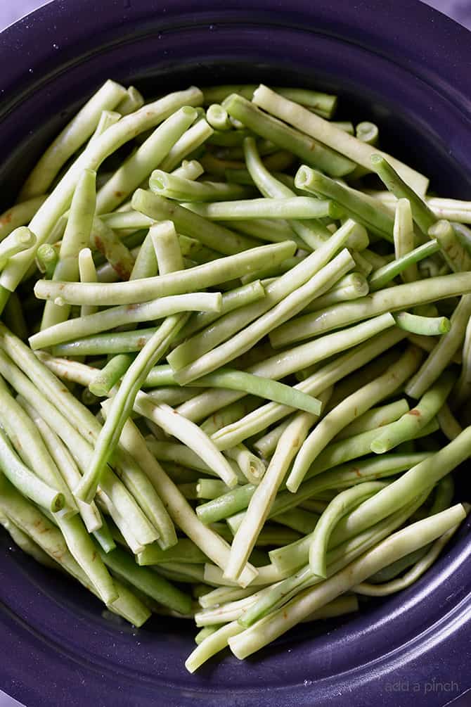 Slow Cooker Green Beans Recipe - These are the best slow cooker green beans and have everyone coming back for more! // addapinch.com