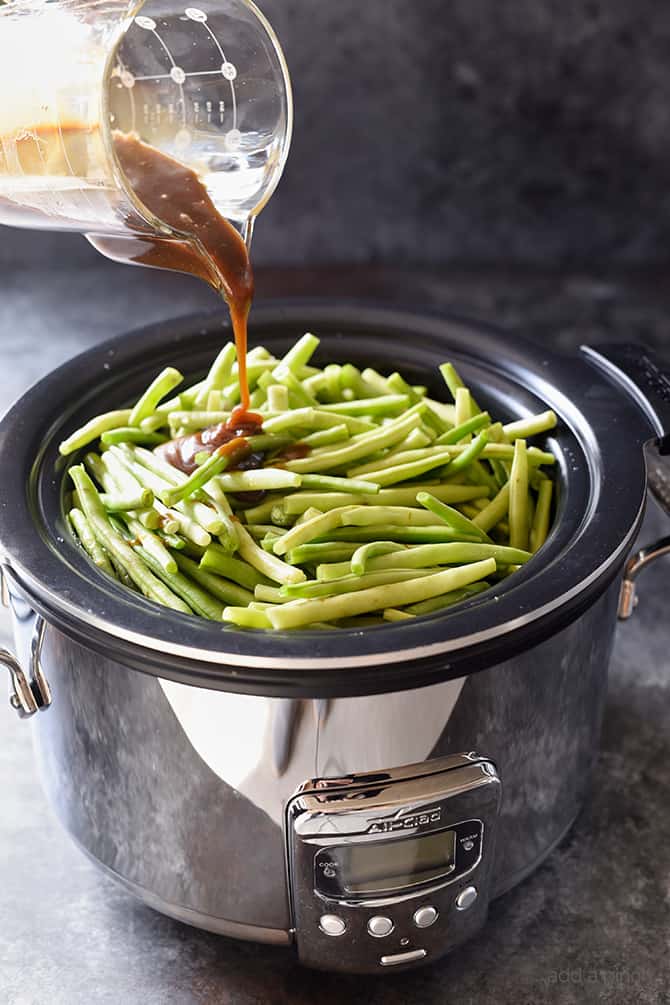 Slow Cooker Green Beans Recipe - These are the best slow cooker green beans and have everyone coming back for more! // addapinch.com