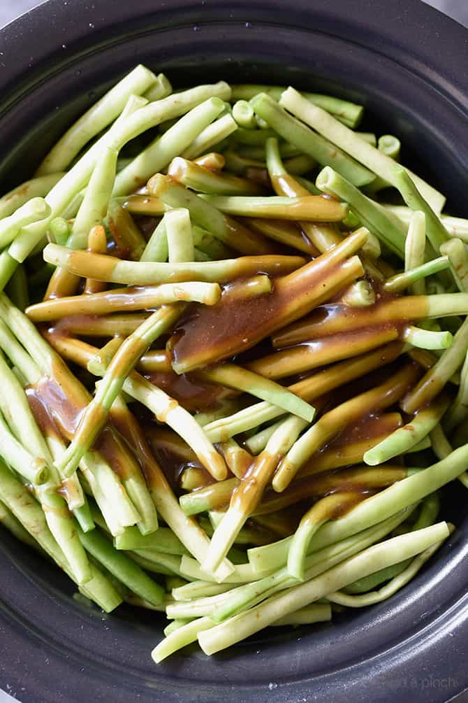 Slow Cooker Green Beans Recipe - These are the best slow cooker green beans and have everyone coming back for more! // addapinch.com