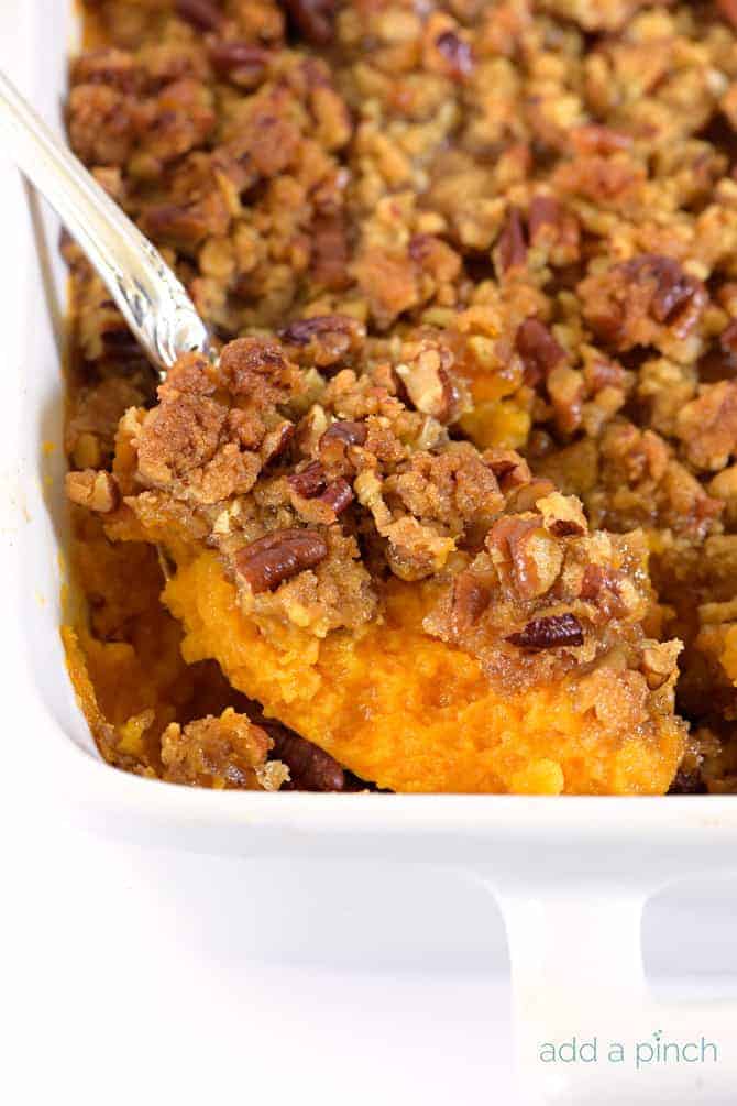 Sweet Potato Casserole topped with pecan streusel in white baking dish