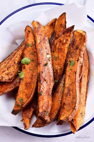 Spicy Sweet Potato Wedges Recipe - Spicy Roasted Sweet Potato Wedges make an easy and delicious recipe! Made with just five ingredients, these roasted sweet potatoes will definitely become a favorite! // addapinch.com